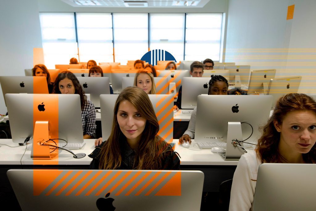 class of students in front of Mac computers admission